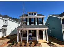 Charming two-story home with black shutters, a welcoming porch, and manicured landscaping at 712 Georgias Landing Pkwy # 13, Raleigh, NC 27603
