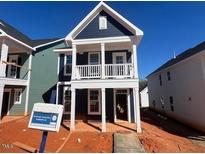 Two story home featuring a covered porch, multiple windows, and blue vinyl siding at 720 Georgias Landing Pkwy # 11, Raleigh, NC 27603