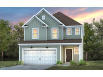 Two-story house with light green vinyl siding, white trim, and a two-car garage at 1013 Freestone Rd, Durham, NC 27703