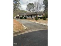 Brick ranch house with attached garage and a spacious yard at 108 Cheney Ct, Garner, NC 27529