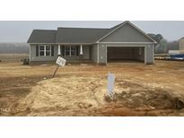 Charming single-story home with gray siding and an attached two-car garage at 185 N Movado Trl, Kenly, NC 27542