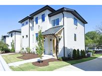 Modern two-story home with white brick exterior and landscaped lawn at 2011 Angier Ave, Durham, NC 27703