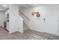 Bright entry with stairs, wood-look floors, and coat rack at 2184 Monk Dr, Haw River, NC 27258