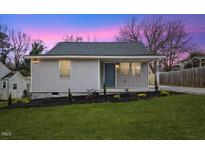 Newly renovated house with gray siding, landscaping, and a covered porch at 2917 State St, Durham, NC 27704