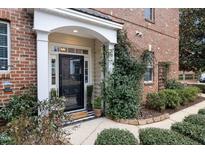 Charming brick home entrance with well-maintained landscaping and a welcoming front door at 3020 Imperial Oaks Dr, Raleigh, NC 27614