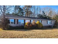 Single-story manufactured home with a brown exterior and landscaping at 320 Eastfield Dr, Rocky Mount, NC 27801