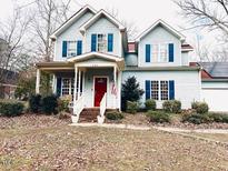 Two-story house with red front door, light blue siding, and a landscaped yard at 321 Fourth Ave, Knightdale, NC 27545