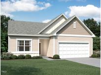 Cream-colored house with gray roof, white garage door, and landscaped lawn at 38 Rolling Banks Dr, Louisburg, NC 27549