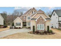 Two-story house with stone and siding, landscaping, and driveway at 455 Shadowdale Ln, Rolesville, NC 27571