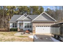 Gray siding two-story house with a white door and attached two-car garage at 46 Trusting Ln, Middlesex, NC 27557