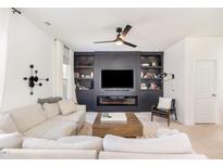 Stylish living room featuring a modern entertainment center with built-in shelves and an electric fireplace at 57 Duchess Ave, Franklinton, NC 27525