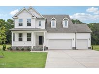 Beautiful two-story home with a three-car garage and covered front porch at 92 Frost Meadow Way, Lillington, NC 27546