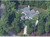 An aerial view of an estate-style home surrounded by mature trees and landscaping at 11201 Jonas Ridge Ln, Raleigh, NC 27613