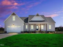 Charming single Gathering home with attached garage and well-manicured lawn in a quiet neighborhood at 1178 Sheriff Johnson Rd, Lillington, NC 27546