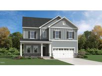 Two-story home with gray siding, white trim, and a two-car garage at 1328 Hazelnut Ridge Ln, Knightdale, NC 27545