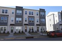 Modern three-story townhouses with gray and beige siding at 1924 Robin Hill Ln, Raleigh, NC 27610