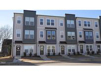 Three-story townhouses with modern design, neutral colors, and landscaping at 1928 Robin Hill Ln, Raleigh, NC 27610