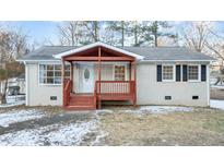 Brick ranch home with covered porch and landscaped yard at 402 Sparella St, Durham, NC 27703