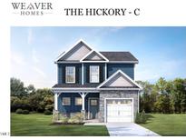 Two-story home with blue siding, white trim, and a two-car garage at 4214 Darroch Rd, Lillington, NC 27546