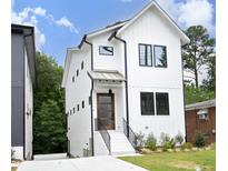 Modern two-story white house with black accents, steps and landscaping at 508 Lakeland St # A, Durham, NC 27701