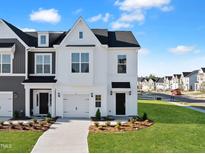 Charming two-story home with landscaped yard, driveway, and attached garage, offering a welcoming curb appeal at 51 Pansy Park # 234, Clayton, NC 27520