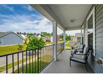 Relax on the balcony with comfortable seating and enjoy neighborhood views in this charming home at 528 Ballast Pt, Clayton, NC 27520