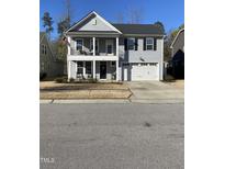 Charming two-story home with a double garage and a cozy front porch at 528 Ballast Pt, Clayton, NC 27520