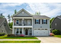 Charming two-story home with a covered front porch and an attached two-car garage at 528 Ballast Pt, Clayton, NC 27520