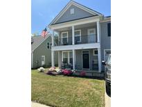 Charming two-story home with a welcoming porch, beautiful landscaping and visible American flag at 528 Ballast Pt, Clayton, NC 27520