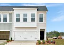 Two-story townhome with attached garage and modern facade at 6 Nettle Ln # 245, Clayton, NC 27520