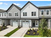 Two-story townhouses with gray and white siding, two-car garages, and landscaping at 607 Marshskip Way, Rolesville, NC 27571