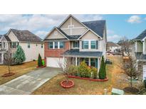 Traditional two-story home with brick accents, blue shutters, and well-maintained landscaping at 7584 Oakberry Dr, Raleigh, NC 27616