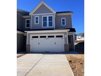New construction two-story home featuring a two-car garage, concrete driveway and neutral gray siding at 8951 Kennebec Crossing Dr # 51, Angier, NC 27501
