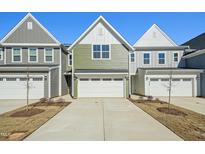Charming townhome showcasing a well-manicured lawn and an attached one car garage at 907 Montague Ave, Durham, NC 27703