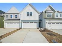 Charming new construction home showcasing a well-manicured lawn and a spacious two-car garage at 911 Montague Ave, Durham, NC 27703