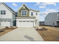 Charming two-story home with white siding, a two-car garage, and a well-lit driveway at 913 Montague Ave, Durham, NC 27703
