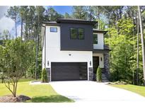 Two-story modern home with white and dark gray siding, stone accents, and a two-car garage at 914 Ardmore Dr, Durham, NC 27713