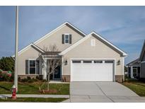 Beige house with white garage door and landscaping at 1254 Linkwood, Homesite 48, Fuquay Varina, NC 27526