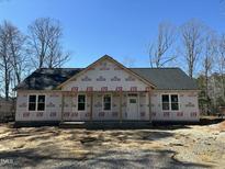 Exterior view of a new home featuring a covered front porch and architectural shingle roof at 132 Black Cloud Dr, Louisburg, NC 27549