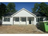 Charming new construction featuring a welcoming front porch and classic white siding at 132 Black Cloud Dr, Louisburg, NC 27549