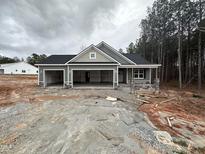 Charming home showcasing a three car garage and stone-accented entrance at 139 Red River Dr, Selma, NC 27576