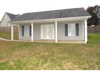 Cozy one story home featuring neutral siding and black shutters at 35 Meadow Ln, Franklinton, NC 27525