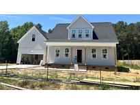 New two-story home with gray siding, a front porch, and an attached two-car garage at 404 Brodie Rose Landing Way, Smithfield, NC 27577