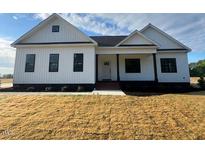 Charming single-story home with white siding and manicured lawn at 541 Delma Grimes Rd, Coats, NC 27521