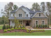 Two-story home with stone and siding, landscaped yard at 63 Rice Rd # 01, Zebulon, NC 27597