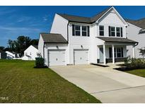 Two-story white house with a two-car garage and a well-manicured lawn at 1312 Anthony Wood Ct, Fuquay Varina, NC 27526