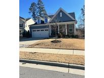 Two-story house with blue siding, attached garage, and a manicured lawn at 1751 Flint Valley Ln, Apex, NC 27502