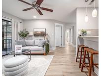 Bright living room with hardwood floors, comfy sofa, and a fireplace at 3805 Chimney Ridge Pl # 008, Durham, NC 27713