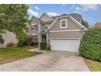 Traditional two-story home featuring a two-car garage, well-maintained lawn, and neutral color scheme at 3905 Song Sparrow Dr, Wake Forest, NC 27587