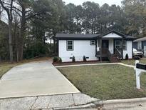 Newly renovated home with a long driveway and landscaped yard at 401 Commonwealth St St, Durham, NC 27703